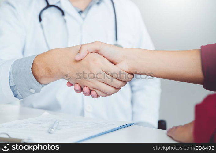 Confident Doctor shaking hands with patients talk in the hospital