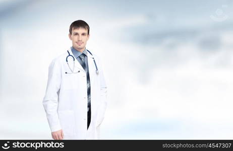 Confident doctor. Young handsome doctor with stethoscope against white background