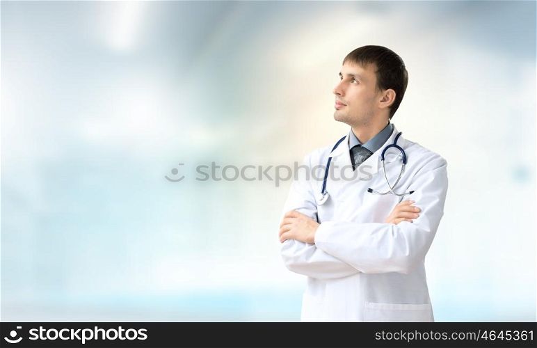 Confident doctor. Young handsome doctor with stethoscope against white background
