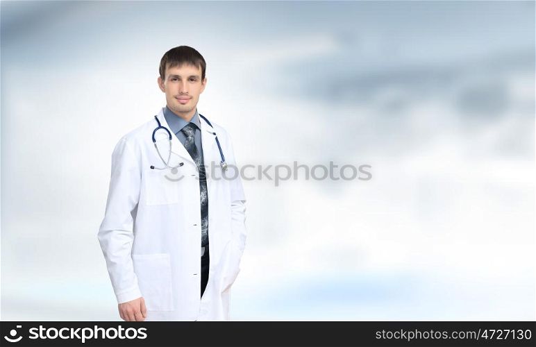 Confident doctor. Young handsome doctor with stethoscope against white background