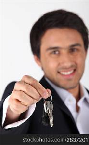 Confident estate-agent handing keys over
