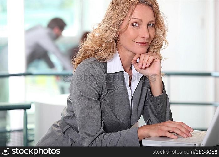 Confident executive with a laptop