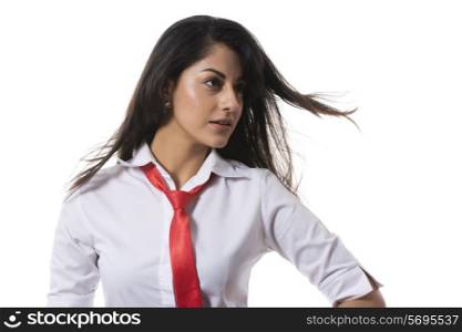 Confident fashionable businesswoman looking away over white background