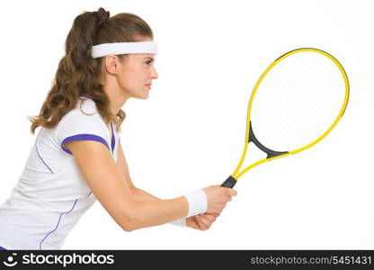 Confident female tennis player in stance . side view