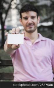 confident guy showing visiting card