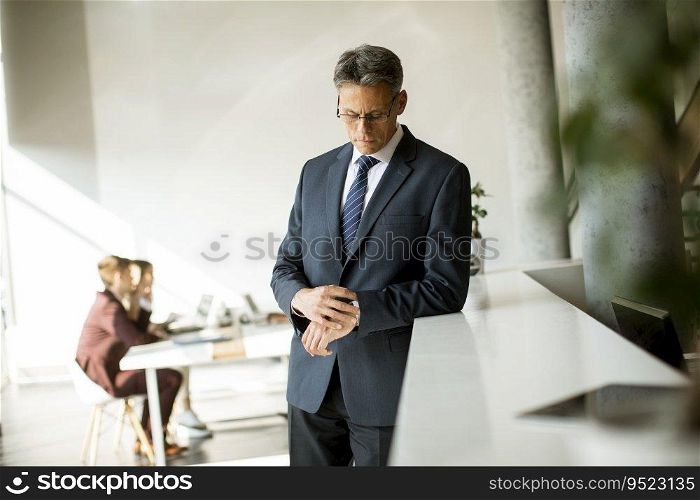 Confident handsome business man standing in the office