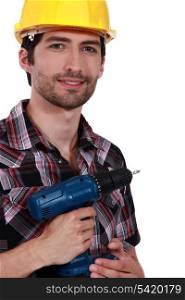 Confident handyman holding drill