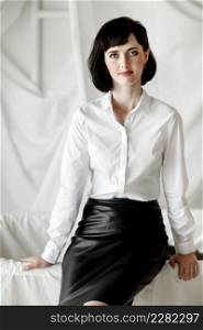 Confident happy attractive business woman. elegant Girl in white shirt and leather skirt sitting at home office. selective focus. Confident happy attractive business woman. elegant Girl in white shirt and leather skirt sitting at home office. selective focus.