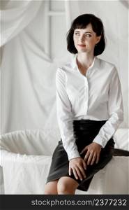 Confident happy attractive business woman. elegant Girl in white shirt and leather skirt sitting at home office.. Confident happy attractive business woman. elegant Girl in white shirt and leather skirt sitting at home office