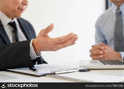Confident insurance agent broker man holding document and present pointing showing an insurance policy contract form to client Business Communication Connection Concept