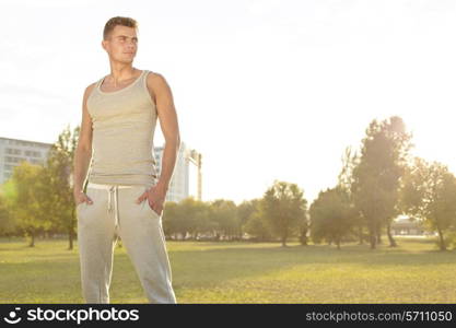 Confident jogger standing in park