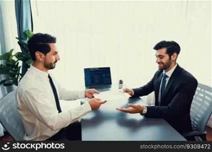 Confident man wearing suit in formal office, hand holding resume paper during job interview. Interviewer asking questions, evaluating candidate qualification and suitability for job position. Fervent. Confident man hand holding resume paper during job interview. Fervent