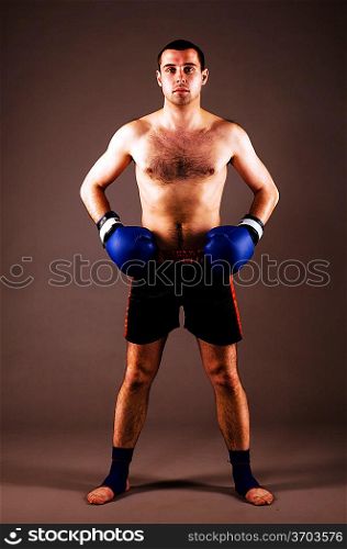 confident mma fighter on gray background