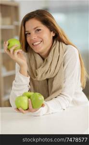 confident smiling woman eating an apples