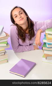 Confident student girl between stacks of books on purple background