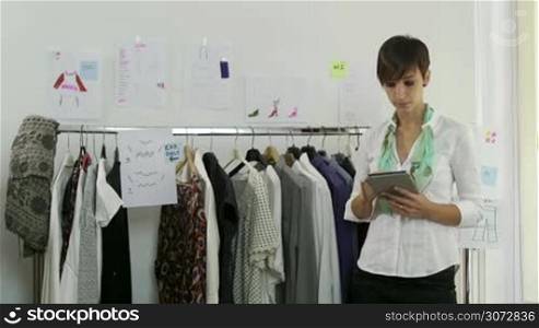 Confident, successful entrepreneur, portrait of happy young woman at work as designer, self-employed tailor with ipad in studio, preparing fashion show. People, career, success, worker in office