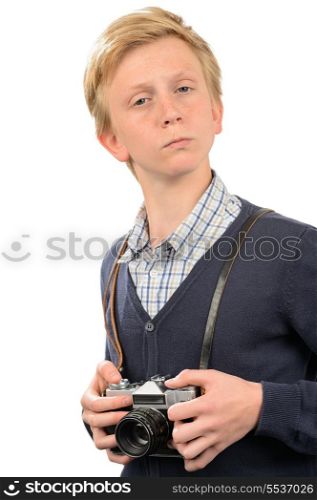 Confident teenage boy with retro camera standing against white background