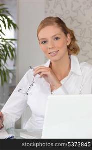 Confident woman sitting at a desk