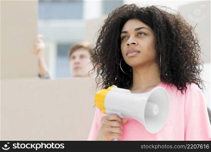 confident woman with curly hair protesting