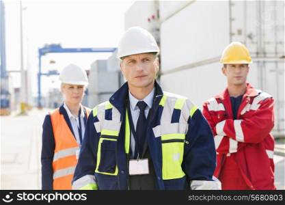 Confident workers standing in shipping yard