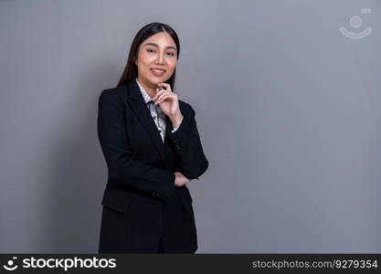 Confident young Asian businesswoman posing in professional outfit on isolated background. Symbol of success, optimism, and corporate office lady for business promotions and advertisements. Jubilant. Confident young Asian businesswoman posing on isolated background. Jubilant