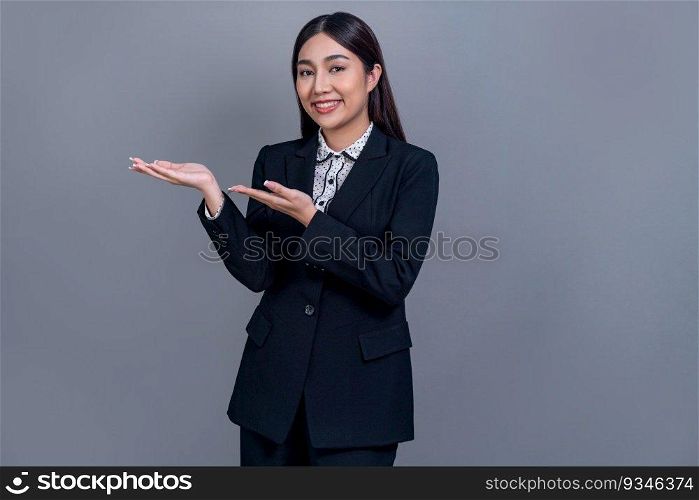 Confident young Asian businesswoman posing in professional outfit on isolated background. Office lady make hand holding gesture for promotions, advertisements or HR recruitment image. Jubilant. Office lady make hand holding gesture for advertisements. Jubilant