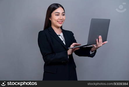 Confident young Asian businesswoman posing with laptop on isolated background. Office lady make hand holding gesture for promotions sales, technology advertisements or HR recruitment image. Jubilant. Office lady make hand holding gesture for advertisements with laptop. Jubilant