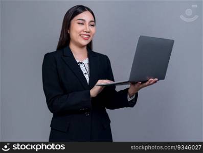 Confident young Asian businesswoman posing with laptop on isolated background. Office lady make hand holding gesture for promotions sales, technology advertisements or HR recruitment image. Jubilant. Office lady make hand holding gesture for advertisements with laptop. Jubilant