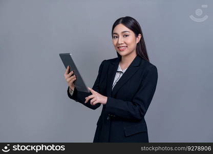 Confident young Asian businesswoman posing with tablet on isolated background. Office lady make hand holding gesture for promotions sales, technology and innovation products advertisements. Jubilant. Office lady make hand holding gesture for advertisements with laptop. Jubilant