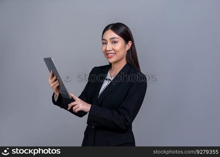 Confident young Asian businesswoman posing with tablet on isolated background. Office lady make hand holding gesture for promotions sales, technology and innovation products advertisements. Jubilant. Office lady make hand holding gesture for advertisements with laptop. Jubilant