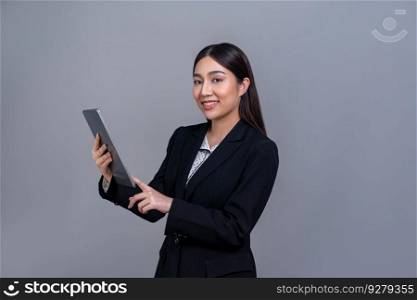 Confident young Asian businesswoman posing with tablet on isolated background. Office lady make hand holding gesture for promotions sales, technology and innovation products advertisements. Jubilant. Office lady make hand holding gesture for advertisements with laptop. Jubilant