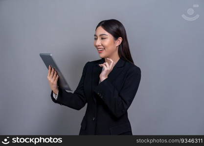 Confident young Asian businesswoman posing with tablet on isolated background. Office lady make hand holding gesture for promotions sales, technology and innovation products advertisements. Jubilant. Office lady make hand holding gesture for advertisements with laptop. Jubilant