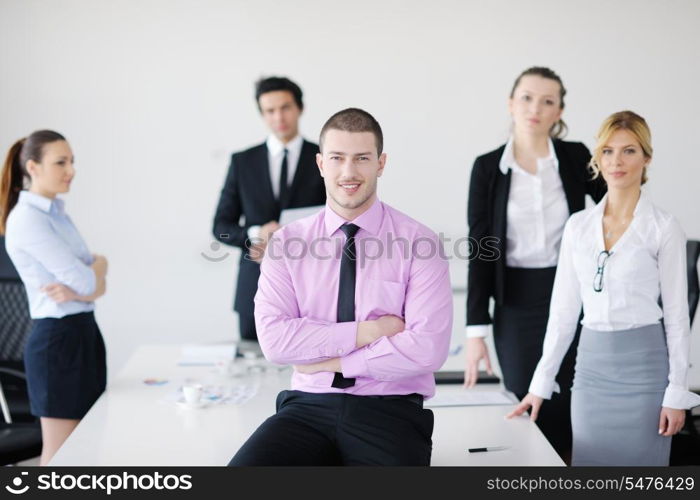 Confident young business man attending a meeting with his colleagues