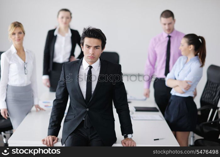 Confident young business man attending a meeting with his colleagues