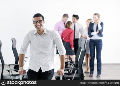 Confident young business man attending a meeting with his colleagues