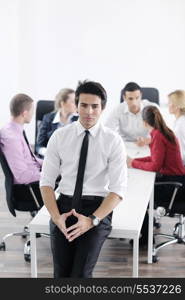 Confident young business man attending a meeting with his colleagues