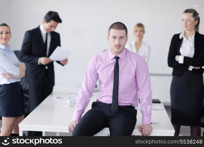 Confident young business man attending a meeting with his colleagues