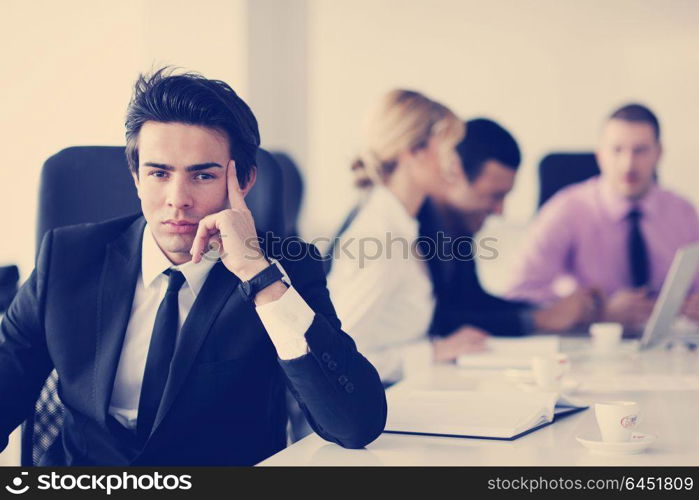 Confident young business man attending a meeting with his colleagues