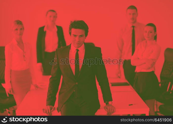 Confident young business man attending a meeting with his colleagues