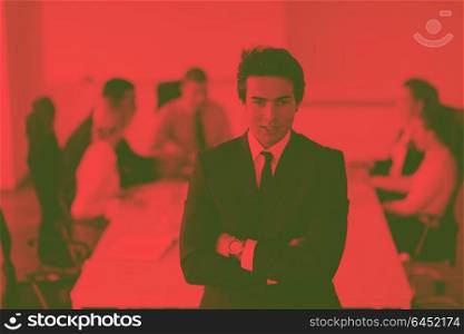 Confident young business man attending a meeting with his colleagues