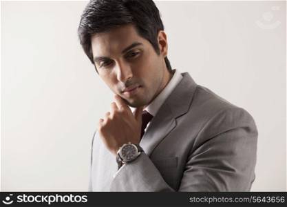 Confident young business man in deep thought