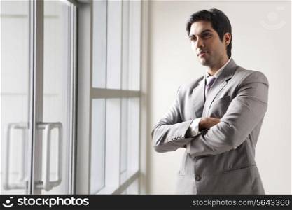 Confident young business man lost in thoughts