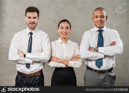 confident young businessmen businesswoman with their arms crossed looking camera