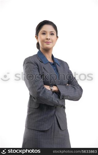 Confident young businesswoman in suit isolated over gray background