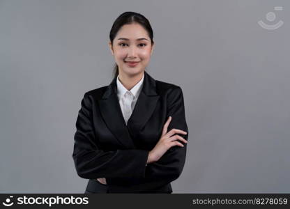 Confident young businesswoman stands on isolated background, posing in formal black suit. Office lady or manager with smart and professional appearance. Enthusiastic. Confident young businesswoman stands on isolated background. Enthusiastic