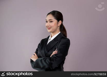 Confident young businesswoman stands on isolated background, posing in formal black suit. Office lady or manager with smart and professional appearance. Enthusiastic. Confident young businesswoman stands on isolated background. Enthusiastic