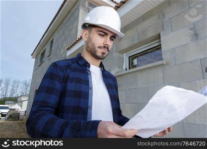 confident young supervisor inspecting process of building overhaul
