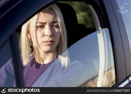 Confident young woman driving car