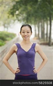 Confident Young Woman in Exercise Clothes in the Park
