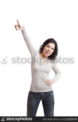 Confident young woman pointing to the air, isolated against white background